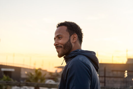 Young sportsman enjoying golden hour light after training session