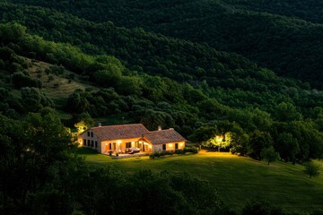 Fototapeta premium Illuminated Country Home in Hills