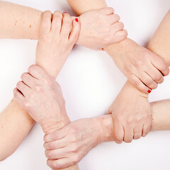 six hands form a circle by holding each other's wrist, white background