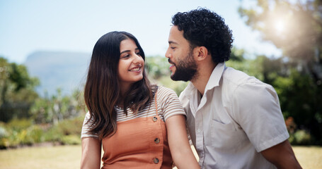 Couple, happy and relax in nature for date, love and outdoor for anniversary picnic. Man, woman and smile in park for healthy relationship, bonding and support on weekend with commitment in marriage