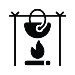 A hanging pot over a fire, symbolizing outdoor cooking and camping.