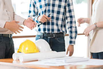 A team at the Architects Group office works tirelessly on blueprints and designs, ensuring that every house and building showcases excellence in architecture.