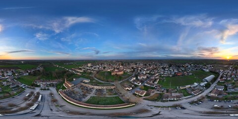 Rocca Casali Pallavicino dominating Monticelli d'Ongina at sunset, panoramic aerial view