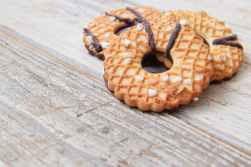 Cookies crispy pastry glazed with chocolate and sugar on the table