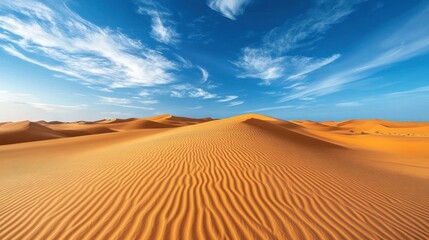 Golden expanse: Serene desert landscape with undulating dunes and vivid blue sky