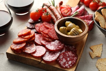 Different smoked sausages slices served on light table, closeup