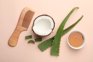 Hair treatment. Fresh coconut, honey, comb and aloe leaves on beige background, flat lay