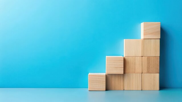 Ascending Wooden Blocks on a Light Blue Background A Concept of Growth, Progress, and Achievement