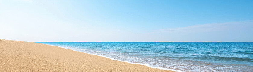 Fototapeta premium serene beach landscape featuring golden sand and calm blue ocean under clear sky evokes sense of tranquility and peace