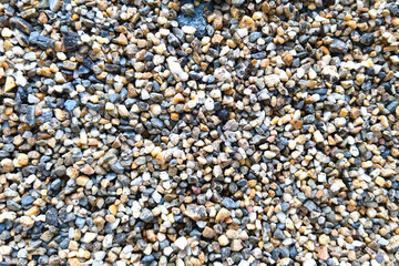 bottom of many round gravel laid on the ground floor for background grey