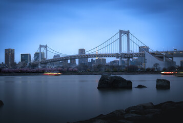 Japan- Kanto Region- Tokyo- Long exposure of Tokyo Bay and Rainbow Bridge at dusk