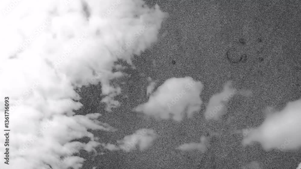 Poster forming clouds over textured gray background, creating dynamic animation scene