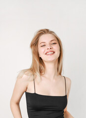 Portrait of a smiling beautiful blonde in a black top.