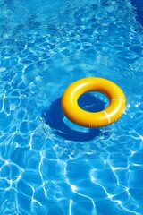 Yellow Inflatable Ring Floating in a Sparkling Blue Swimming Pool, Summer Fun and Relaxation Concept