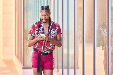 Stylish androgynous man using smartphone in urban setting