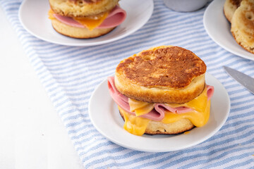 Breakfast crumpet sandwich, british pancake scones burger with cheese and ham