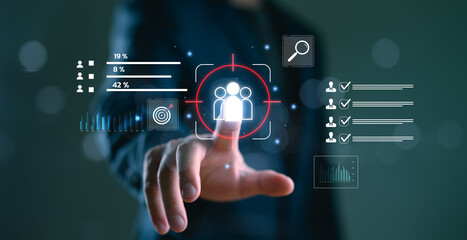 Digital marketing strategy and audience targeting concept. Businessman interacts with data analytics dashboard, customer engagement insights, online advertising, Customer Relationship Management.