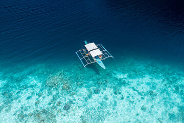Travel background of tropical blue sea and local crab boat in Philippines