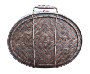 Old brown suitcase with a woven handle sits on transparent background.