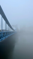 Car Bridge over the river in the city during fog. Grunwald Bridge, Wroclaw Poland