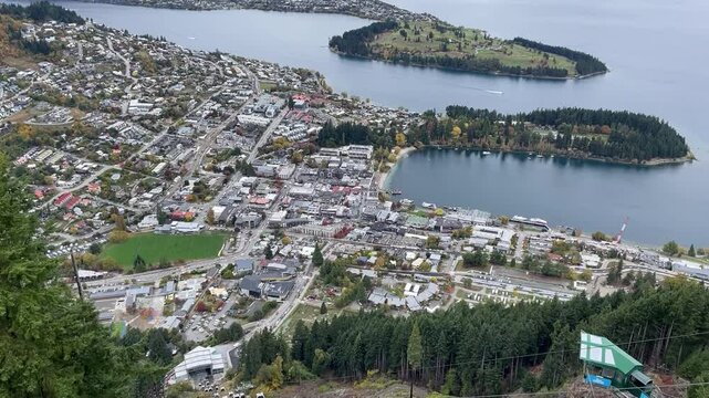 A beautiful panorama of the town of Queenstown, Lake Wakatipu and the steep cable cars going up the mountain. View from Skyline Queenstown, Otago, New Zealand, South Island