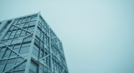 Obraz premium Modern building sharply rises against a cool blue sky. AI Generated