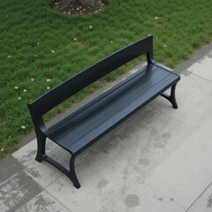 sleek black bench sits on paved surface surrounded by lush green grass, inviting relaxation and contemplation