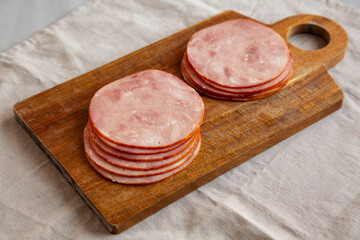 Organic Smoked Cold Cuts Deli Meat Ham on a wooden board, side view.
