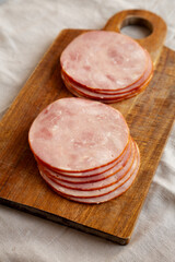 Organic Smoked Cold Cuts Deli Meat Ham on a wooden board, side view.