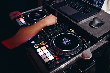 DJ Playing Music at Mixer in Night Club