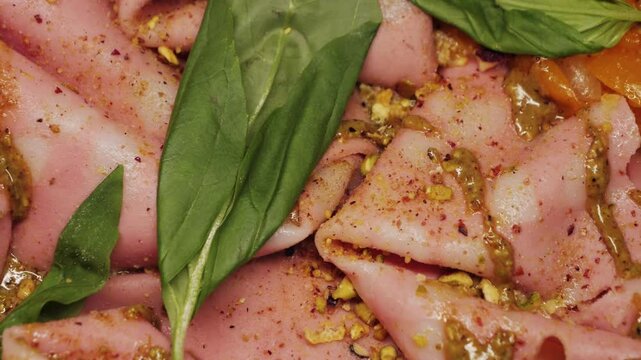 Delicious pizza with cheese mozzarella, sausage mortadella with pistachio, stracciatella burrata and tomatoes cherry yellow. Concept of italian food and cuisine. High quality 4k footage