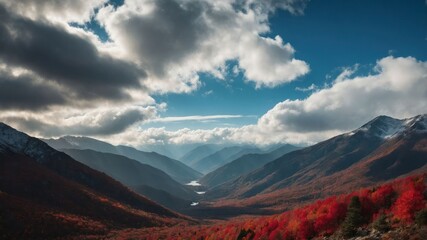 A breathtaking mountain landscape showcasing vibrant autumn foliage and dramatic cloud formations.