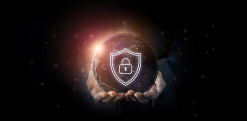 Global cybersecurity protection concept. A person holds a glowing digital earth with a shield and padlock icon overlay, representing cybersecurity, digital and data protection, network security.