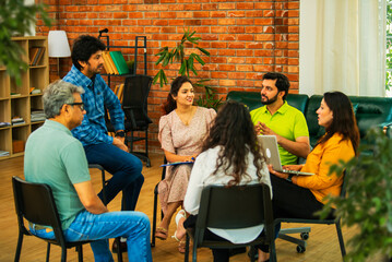 Diverse Indian startup team collaborating on mental health workplace wellness in a business meeting