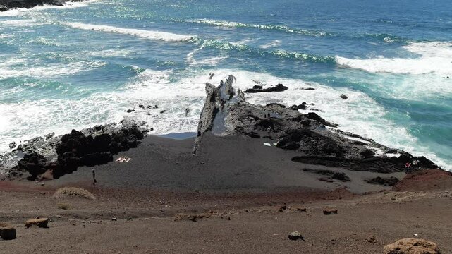El Golfo Spain 03 11 2025 The rugged coast of El Golfo, Lanzarote, near Charco Verde. People enjoy the sea and shoreline, surrounded by volcanic cliffs and the stunning Atlantic Ocean views.