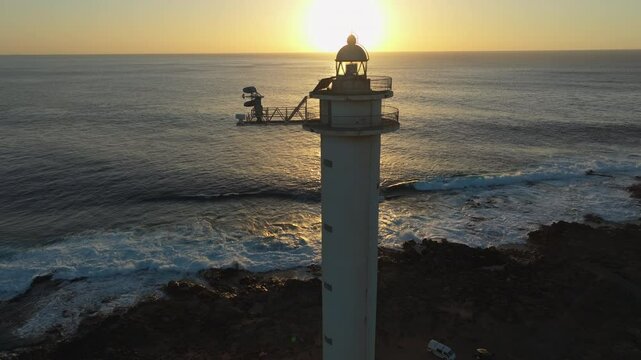 Beacon of Light: Pechiguera Lighthouse in Playa Blanca, Lanzarote Under an Orange Sky. Canary Islands, Spain.