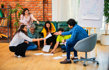 Fototapeta premium Indian Young professionals discussing ideas, planning a business project with documents in office