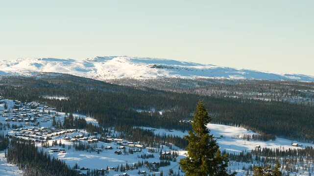 Snow covered mountains and forests in rural Norway on a beautiful sunny day