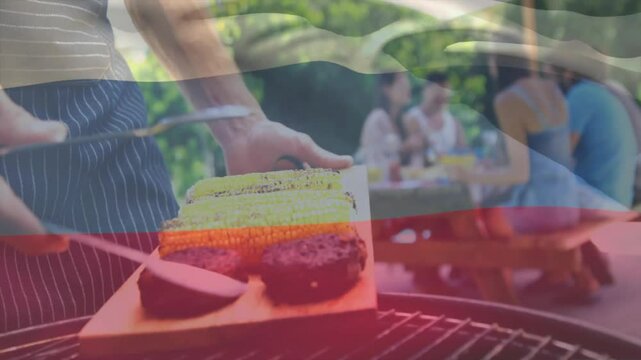 Grilling corn and meat with friends gathered, flag animation overlay in background