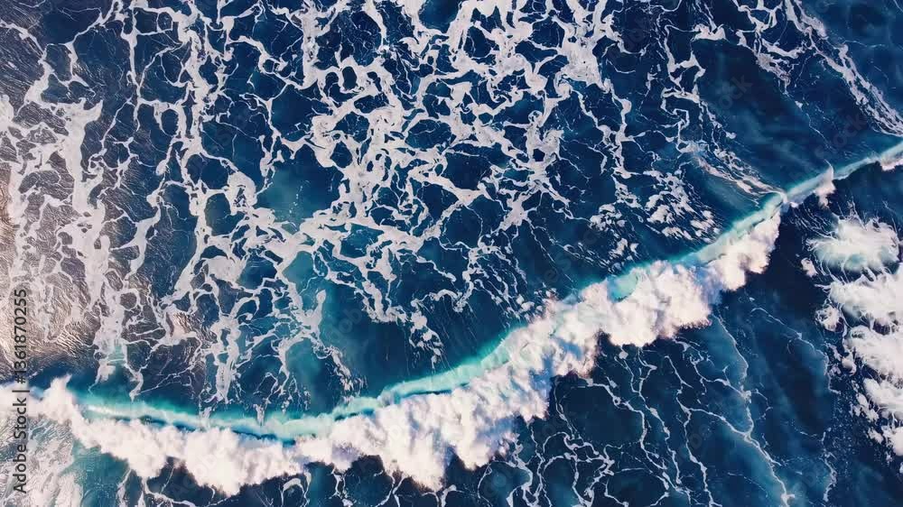 Poster aerial view of ocean waves creating intricate patterns. the video captures the dynamic, abstract bea
