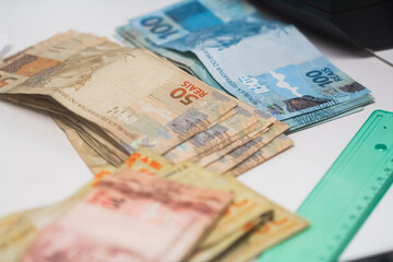 Businessman counting and exchanging money - Brazilian Real - Reais.