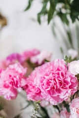 Close-up of vibrant pink carnations in soft focus at local flower shop. Highlights sustainable floristry, seasonal blooms, and eco floral trends