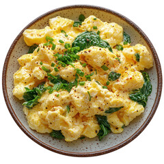 A plate of fluffy scrambled eggs with saut?ed spinach, isolated on a white background.