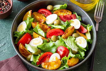 Salad with potatoes, tomatoes, olives and eggs. Healthy food. Vegetarian food.