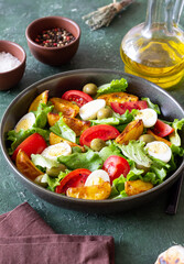 Salad with potatoes, tomatoes, olives and eggs. Healthy food. Vegetarian food.