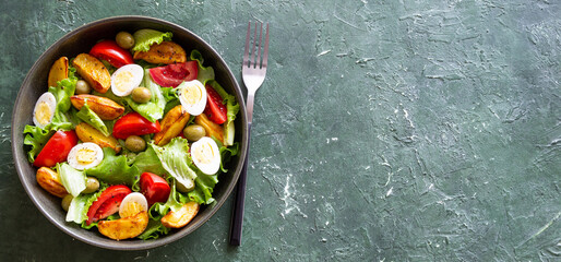 Salad with potatoes, tomatoes, olives and eggs. Healthy food. Vegetarian food.