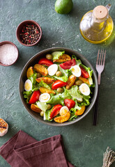 Salad with potatoes, tomatoes, olives and eggs. Healthy food. Vegetarian food.