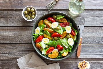 Salad with potatoes, tomatoes, olives and eggs. Healthy food. Vegetarian food.