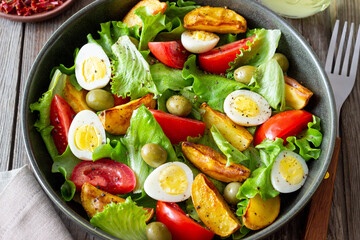 Salad with potatoes, tomatoes, olives and eggs. Healthy food. Vegetarian food.