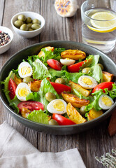 Salad with potatoes, tomatoes, olives and eggs. Healthy food. Vegetarian food.